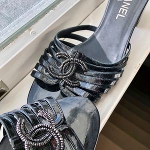 Black Chanel strap sandals, low heel.